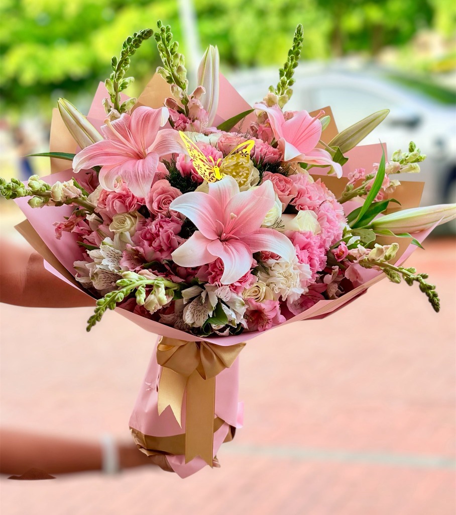 Hermoso ramo de flores rosadas con lirios, claveles y mariposa decorativa - La Casa de las Flores Paz de Ariporo